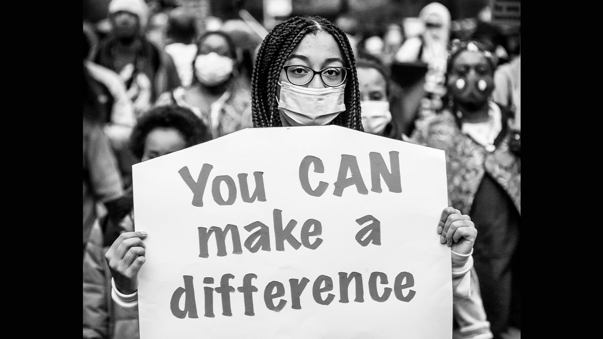 Image of woman holding a sign stating You CAN make a difference
