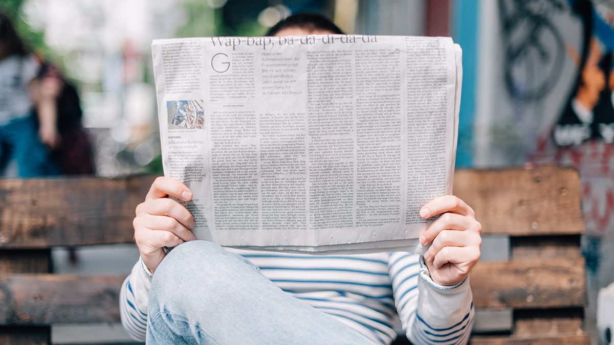 image of someone reading a newspaper